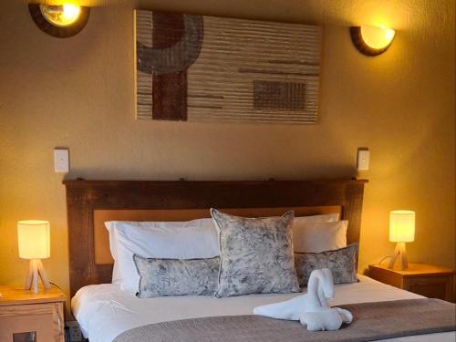 a bedroom with a bed with a stuffed animal on it at Akasia - 333 in Hoedspruit