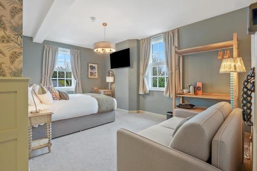 a bedroom with a bed and a couch at The Slow & Easy in Lostock Gralam