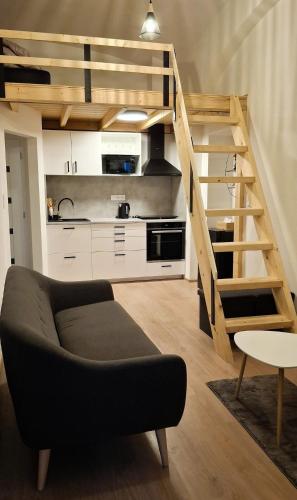 a living room with a couch and a loft at Palác Apartment in Strakonice