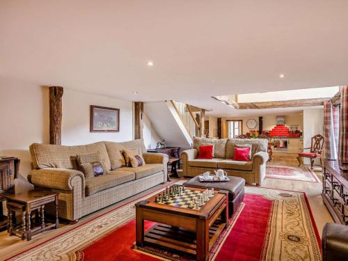 a living room with a couch and a chessboard on a table at 2 Bed in Thetford oc-57885 in Saham Toney