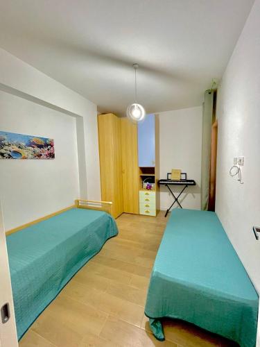 a bedroom with two green beds in a room at Casa Vacanza Regina in Scalea