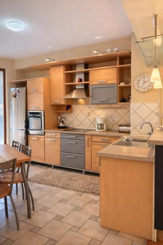 a kitchen with wooden cabinets and stainless steel appliances at Sim apartment in Skopje in Skopje