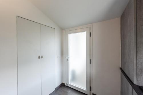 a room with white cabinets and a mirror at Rapallo - Monolocale con piscina in Rapallo