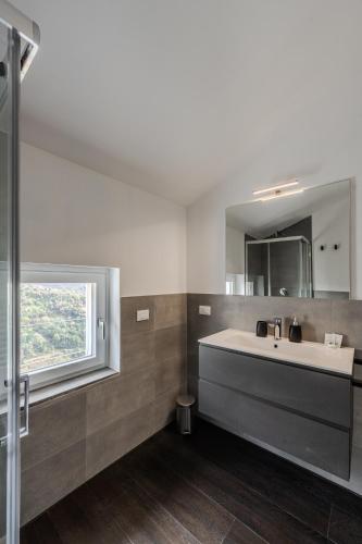 a bathroom with a sink and a window at Rapallo - Monolocale con piscina in Rapallo