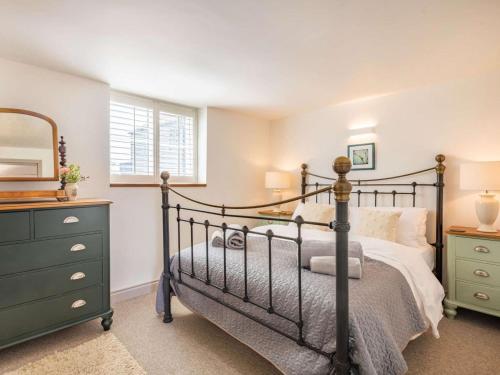 a bedroom with a bed and a dresser and a mirror at 3 Bed in Kings Lynn oc-88223 in Beeston