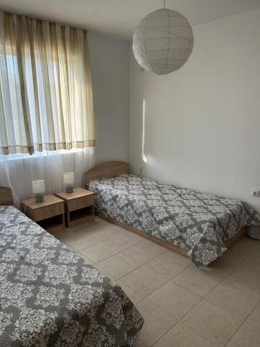 a hotel room with two beds and a lamp at Villa Campo in Ezerets