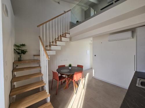 a kitchen and dining room with a table and stairs at Salionze Apartments in Salionze