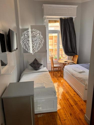 a bedroom with two beds and a table and a desk at colombia inn cairo in Cairo