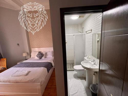 a bedroom with a bed with a lion head on the wall at colombia inn cairo in Cairo