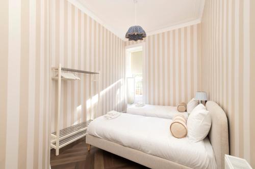a bedroom with two beds and a window at JOIVY Family Flat near Leith in Edinburgh