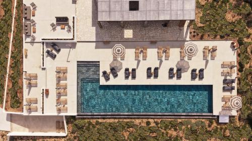 an overhead view of a swimming pool with chaise lounges at Ovea Paros in Naousa