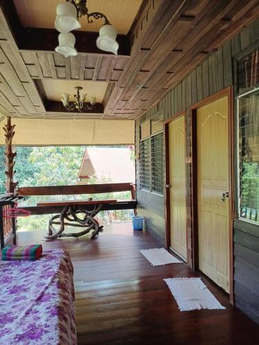 a room with a table and a wooden floor at Koh Kood Little Hut in Ko Kood