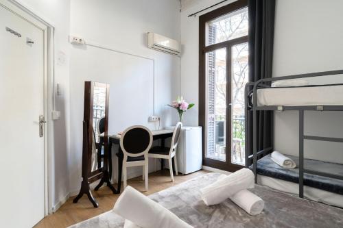 a bedroom with a desk and a bunk bed at Hostal Sant Antoni in Barcelona