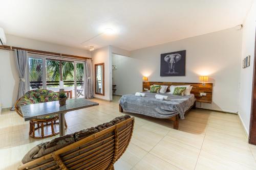 a living room with a bed and a table at Authentic Nest in La Gaulette