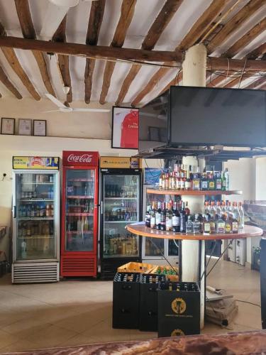 a store with two coca cola machines in a room at KimyaKimya Pub & Lodge in Dar es Salaam