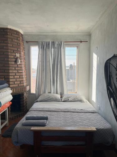 a bedroom with a large bed with a window at El quincho in San Pedro