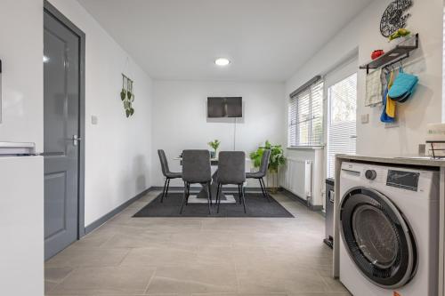 a kitchen and dining room with a washing machine and a table at Premium Serviced Accommodation Rooms Nottingham - All with Ensuites in Nottingham