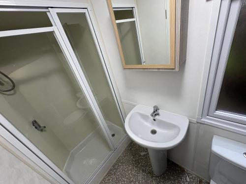 a bathroom with a shower and a sink at Caravan 607 in Clacton-on-Sea
