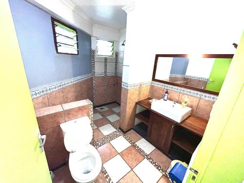 a bathroom with a toilet and a sink at Uhuru Peak Hostel in Moshi