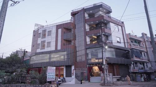 a tall building on a city street at Hotel Golden Aura Inn in Gwalior