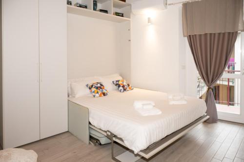 a bedroom with a bed with white sheets and pillows at Dimora del Borgo in Lovere