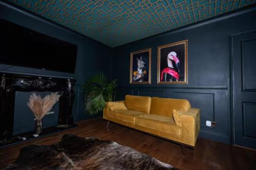 a living room with a couch and a tv at Bold Coastal Retreat with Boudoir Interiors, Felpham Village in Bognor Regis