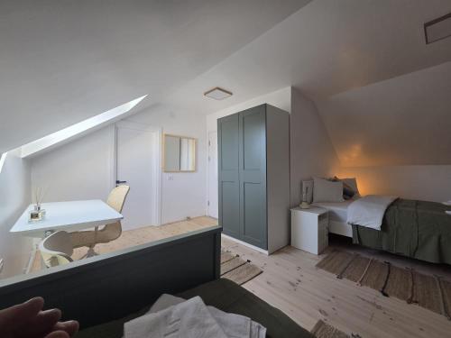 a bedroom with a bed and a desk in a room at La casa morarului in Cârțișoara