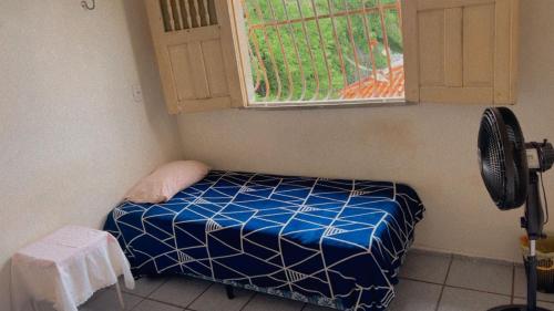 a small room with a bed and a window at Hostel Teresina in Teresina