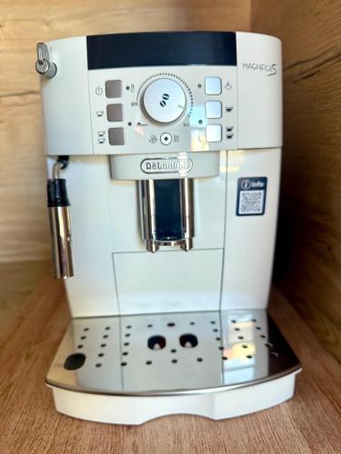 a coffee maker is sitting on a stand at Premium Apartment Centrum in Poprad