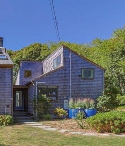 a blue brick house with a porch at Wellfleet Vacation Townhome with Direct Marsh Views & Spa in Wellfleet
