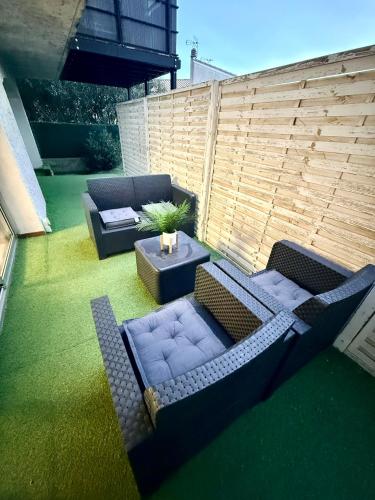 an outdoor patio with two couches and a table at Chez Niko in Martigues