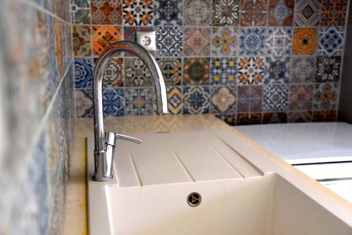 a kitchen sink with a faucet on top of it at Stone Apartments Kythnos in Kanala