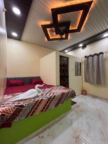 a bedroom with a large bed with a white swan on it at HOTEL o GUMTHI STAY INN in Patansaongi
