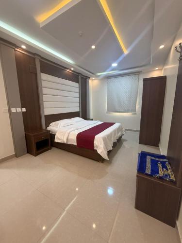 a bedroom with a large bed in a room at ثار بارك للشقق المخدومة in Qushayya
