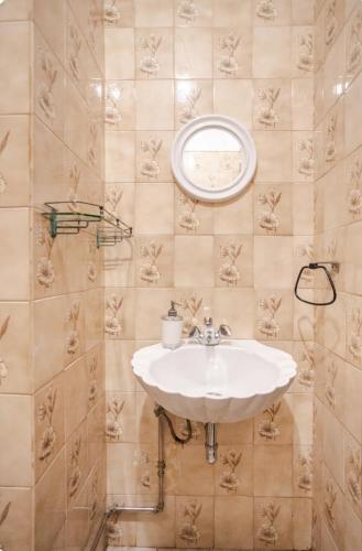 a bathroom with a sink and a mirror at Apartment Rustic Oporto in Porto