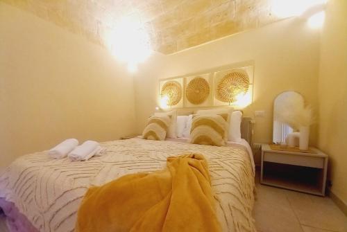 a bedroom with a large white bed in a room at Radici Cave & Suite in Matera