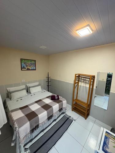 a bedroom with a large bed in a room at Estação Noronha in Fernando de Noronha