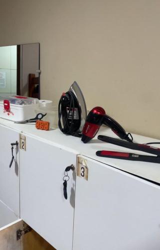 a white cabinet with a hair dryer on top of it at Estação Noronha in Fernando de Noronha