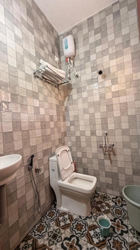 a bathroom with a toilet and a sink at Athiratha Living in Malpe