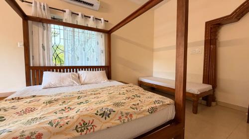 a bedroom with a bed and a window at Athiratha Living in Malpe