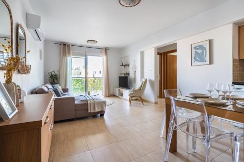 a living room with a couch and a table at Relaxing 2BDR Retreat in Protaras in Paralimni