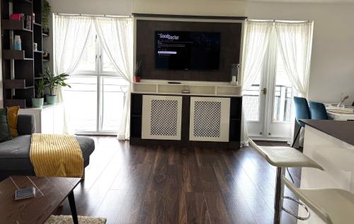 a living room with a flat screen tv on a wall at London Excel O2 Arena - Apartment with River view in London
