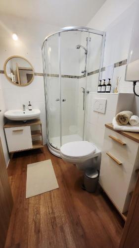 a bathroom with a shower and a toilet and a sink at Downtown Boho Botanico in Brno
