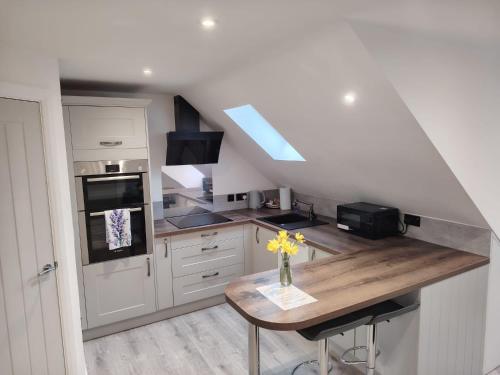 a kitchen with a wooden counter top in a room at Lavender Lodge - Modern apartment in York, near Racecourse in Copmanthorpe