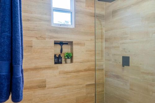 a shower with a glass door with a plant in it at Bambu Beach Haus Coronado in Las Lajas