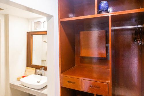 a bathroom with a sink and a toilet and a mirror at Zara Beach Resort Koh Samui in Lamai
