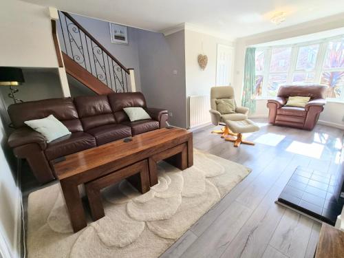 a living room with a couch and a coffee table at Alverstoke Manor - family home with pool table in Alverstoke