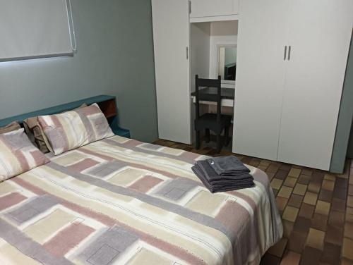 a bedroom with a bed with towels on it at Pennington Holiday Cottages in Pennington