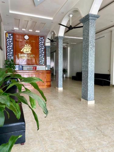 a lobby with a large room with columns and a bar at Trung Liên Hotel in Đảo Cô Tô