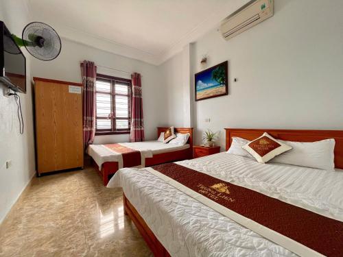 a hotel room with two beds and a window at Trung Liên Hotel in Đảo Cô Tô